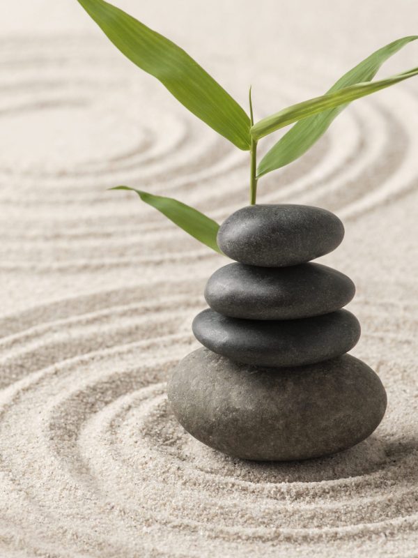 Stacked zen stones sand background art of balance concept